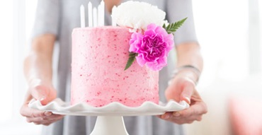 a pink cake with flowers on it