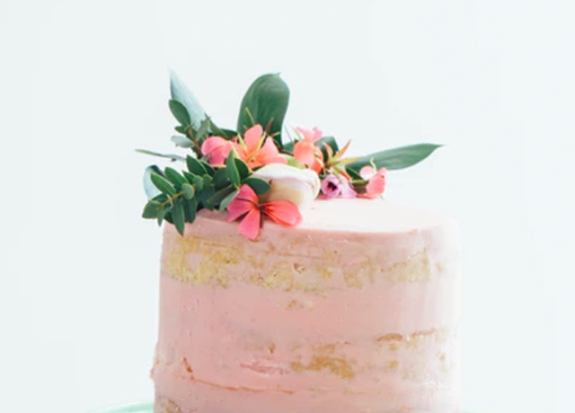 a pink cake with flowers on top